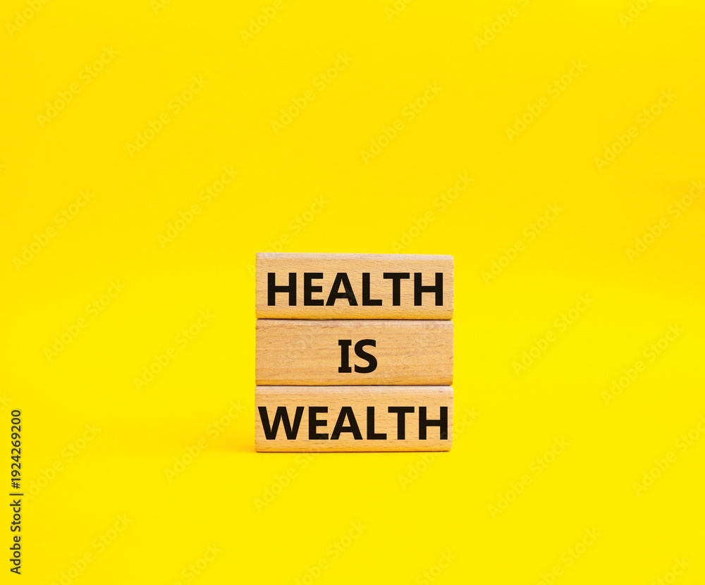 Fototapeta premium Health is Wealth symbol. Concept word Health is Wealth on wooden blocks. Beautiful yellow background. Medicine and Health is Wealth concept. Copy space