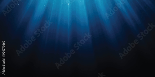 Sunlight beams penetrate deep into the mysterious dark blue ocean water, creating an ethereal underwater scene
