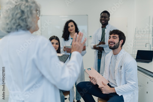 Tablou pe pânză Professor teaching diverse medical students in science class