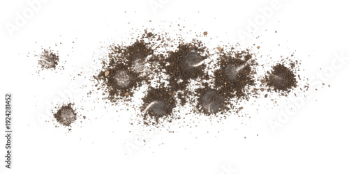 Several small piles of dark brown soil and dirt scattered across a clean white background, creating an abstract texture.
