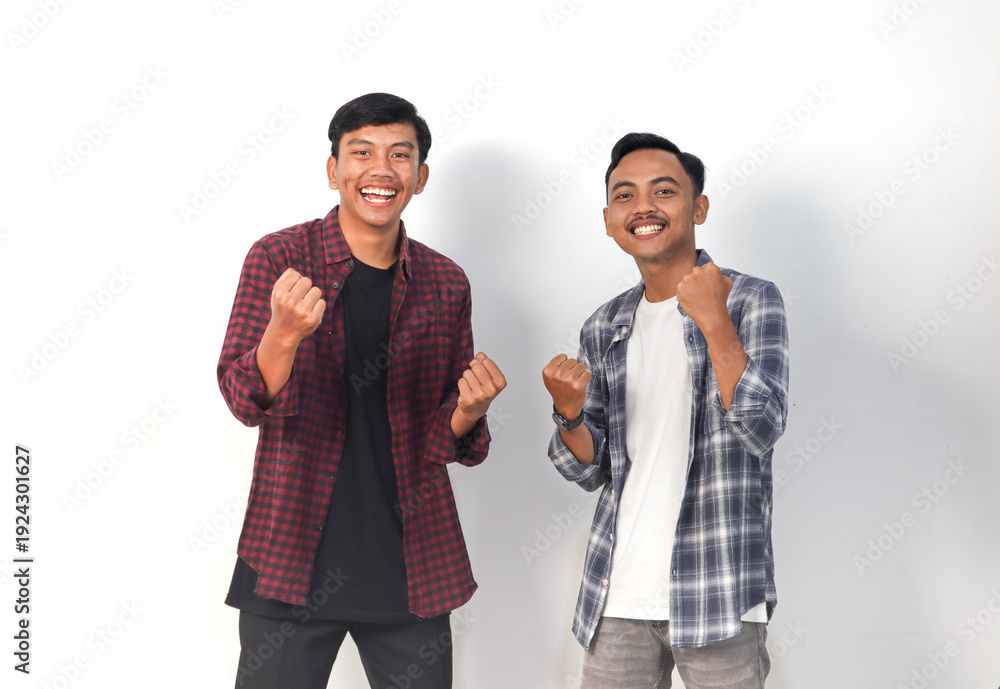Obraz premium Asian men wearing shirts with joyful expressions are celebrating on an isolated white background.