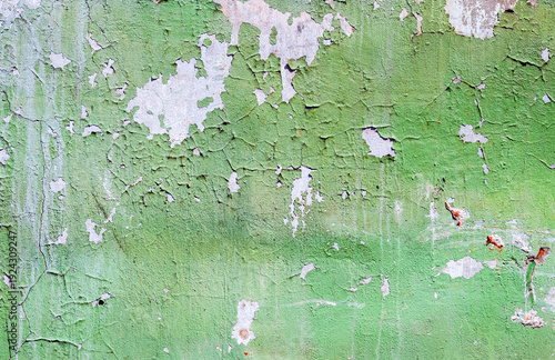 Texture of old concrete wall with cracks and peeling paint. Cracked grunge wall background