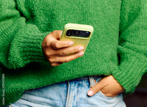 Anonymous woman uses a smartphone.