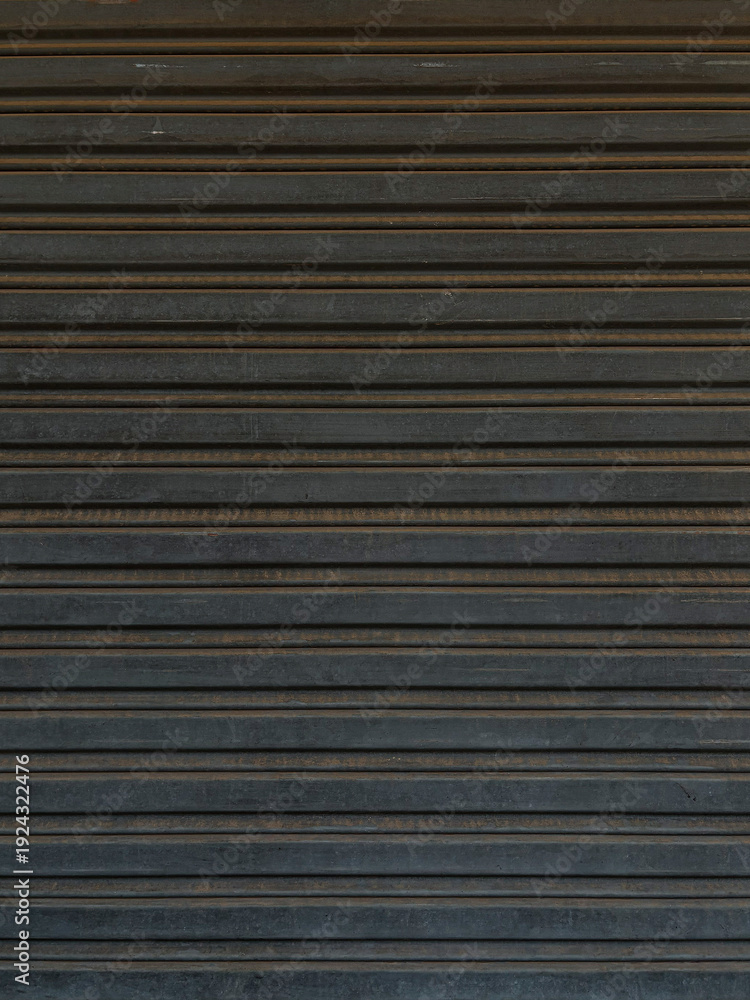 Obraz premium A close-up view of a dark gray metal shutter with horizontal slats