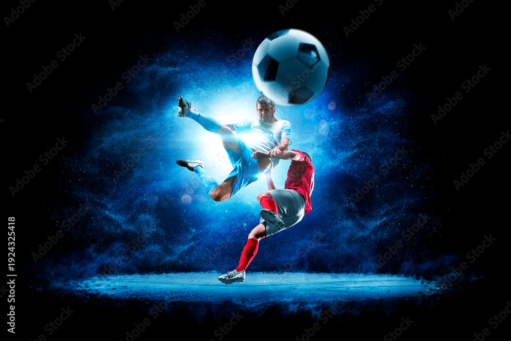 Fototapeta premium Soccer. Soccer players on a beautiful black background with a flash of light behind them. Isolated on a black background. Sports