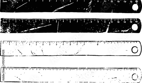 Four worn measuring rulers laid out horizontally with visible scratches and marks