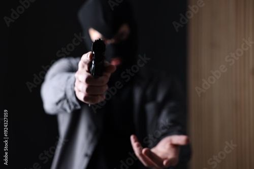 Fényképezés Dangerous criminal holding gun indoors, selective focus