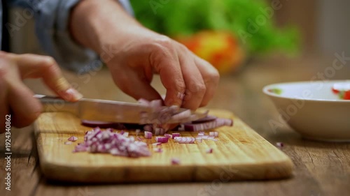 Detailed shot of male hands chopping onion with precision, capturing skill, texture, and the essence of fresh, healthy home meal prep.