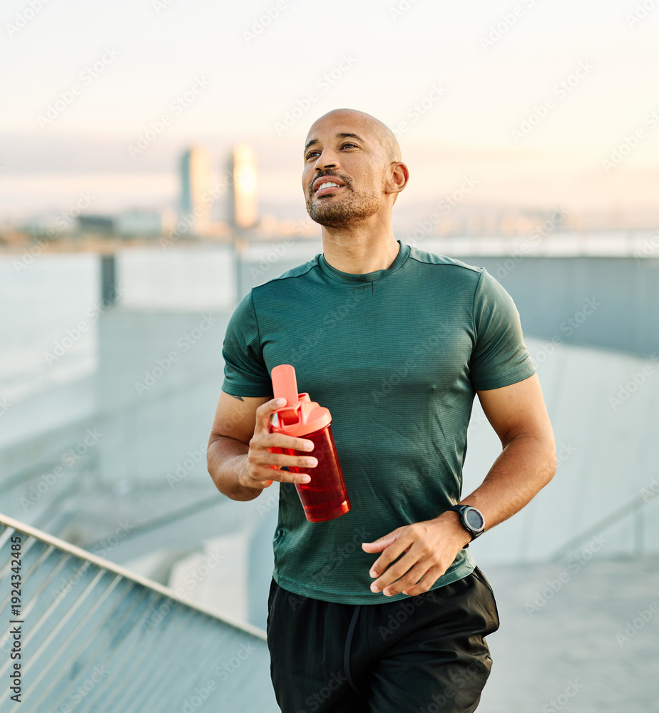 Ταπετσαρία Portrait of a happy man holding a bottle of water refreshment posing and smiling after exercicing outdoors