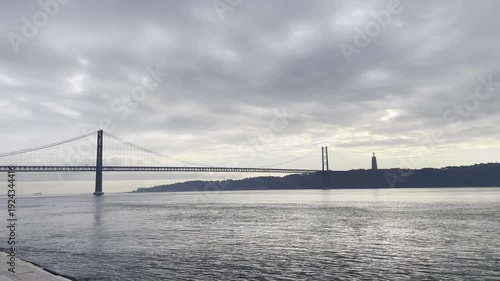 Wallpaper Mural Iphone Pro Max vertical phone video. 25th April bridge and waterfront in Lisbon, Portugal. Winter, overcast, December Torontodigital.ca