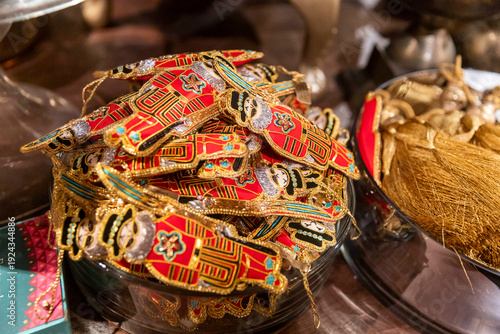 Tableau sur toile London, UK, 12 December 2026, Handcrafted embroidered nutcracker christmas ornaments in a glass bowl for sale