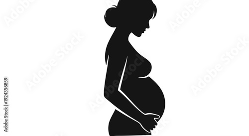 Silhouette of a pregnant woman standing in profile with hands on belly.