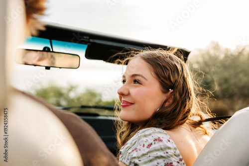 Close up of a young girl smiling in convertible 