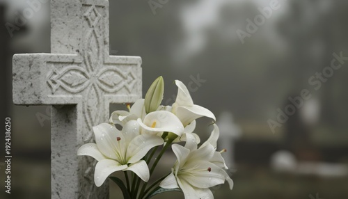 White marble catholic cross with blooming lilies in a cemetery as a symbol of remembrance and commemoration