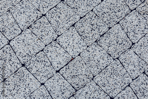 The texture of gray granite paving slabs