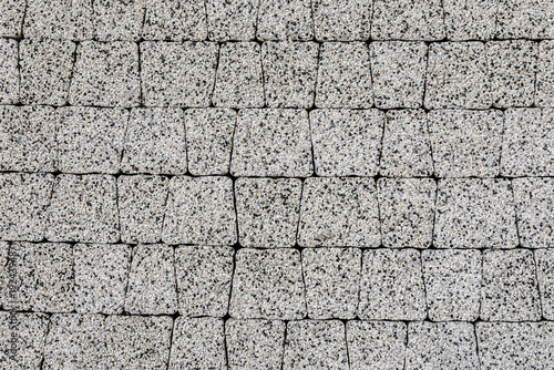 The texture of gray granite paving slabs