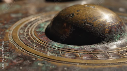 Close up Of Aged Bronze Disc With Intricate Patterns And Verdigris Patina