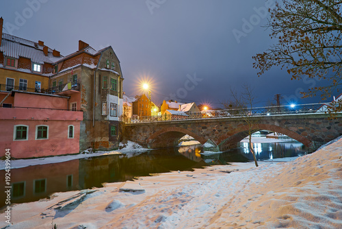 Lidzbark Warminski, Poland - february 17, 2026 - Historic stone bridge over the Lyna River in winter