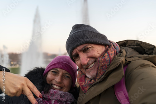 Smiling couple enjoying a european holiday, capturing their travel memory in paris