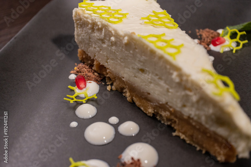 A slice of cottage cheese pie on a plate with beautiful decoration
