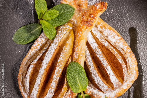 Dessert of fried pear sprinkled with powdered sugar