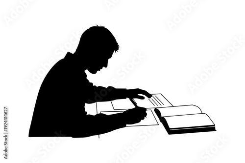Silhouette of a young student diligently studying and writing notes at a desk with an open book