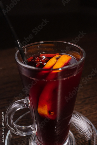 Mulled wine in a glass on a wooden table