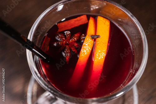 Mulled wine in a glass on a wooden table