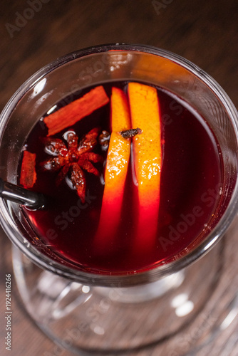Mulled wine in a glass on a wooden table
