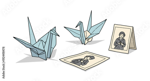 Two origami paper cranes and two framed portraits of a woman on a white background