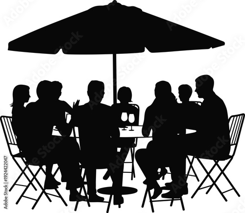 Silhouette of a large family or group of friends enjoying an outdoor dinner party around a table under a patio umbrella