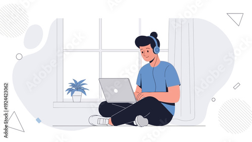 Man with Headphones Working on Laptop by Window