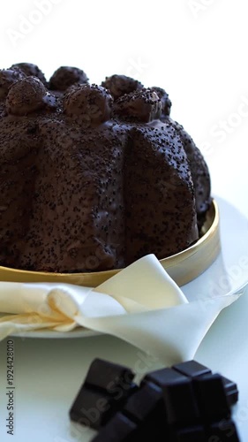 Vertical video of Profiteroles cake on white background and dark chocolate 