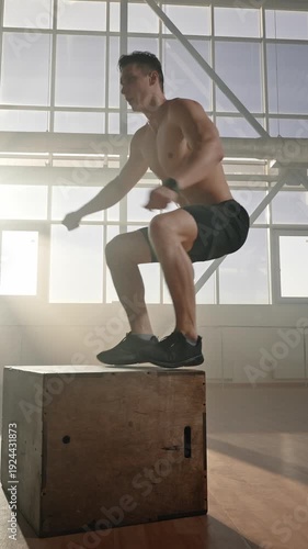 Determined shirtless male athlete strengthen legs and buttocks muscles, jumps up on box. Slow motion