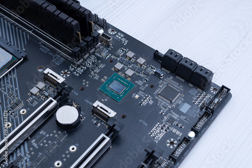 Photos Motherboard chipset without heatsink, detailed semiconductor component on modern