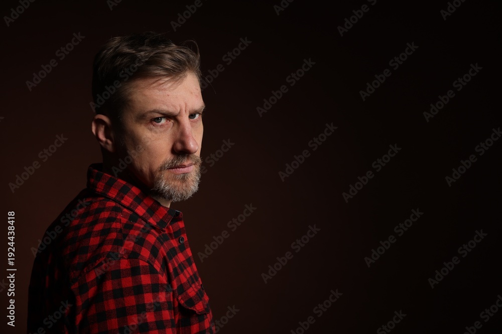 Fototapeta premium Man with beard on dark background. Space for text