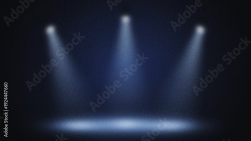 Obraz na plátně Three bright spotlights illuminating a dark stage with blue haze