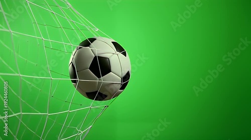 Soccer ball scoring a dramatic goal with the white net rippling powerfully against a vibrant, solid green screen background ready for digital compositing effects