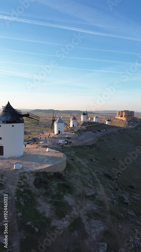 4K vertical aerial drone shot of windmills at sunset in Consuegra, Spain
