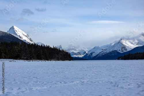 Dynamic view of beautiful Rocky mountains and frozen Maligne lake in Jasper National Park