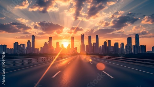 Sunset over a city skyline with a highway