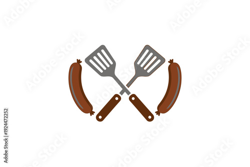 Spatulas crossed over each other with sausages on either side for barbecue cooking