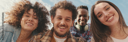 Wallpaper Mural Happy smiling friends make a video call from a mobile phone. Four students wave their hands in greeting. Panoramic Torontodigital.ca