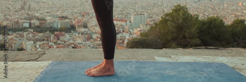 Wallpaper Mural Young woman practices yoga at sunrise on viewing platform. Panoramic Torontodigital.ca