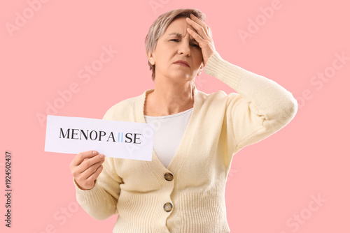 Mature woman holding paper ...