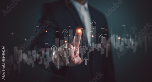 Businessman touching virtual glowing financial graph and candlestick chart. Concept of stock market investment, data analysis, and business growth strategy with upward arrows and profits.