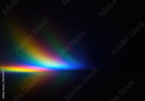Diffused spectral light colors creating a subtle rainbow gradient across a dark, smooth surface. Ideal abstract background with copy space, futuristic, science, spectrum
