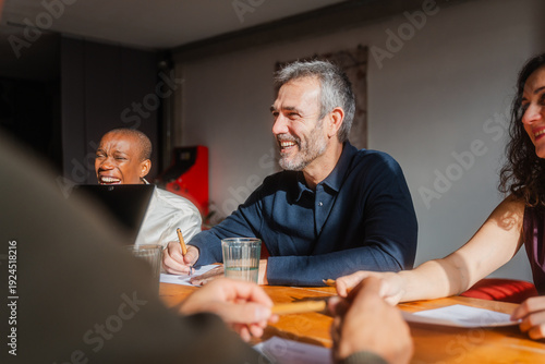 Colleagues engaged in conversation in the conference room