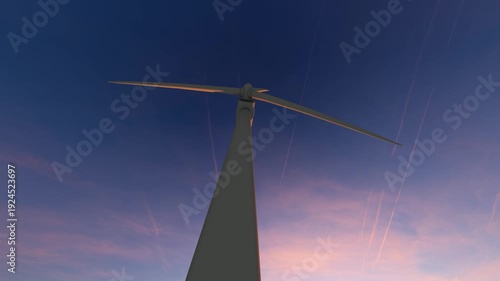 Wind Turbine Rotating Against a Dramatic Sunset Sky.