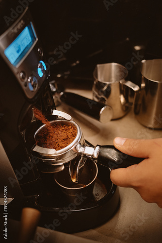 Φωτογραφία Close-up of freshly ground coffee being dispensed into a portafilter from an espresso machine grinder